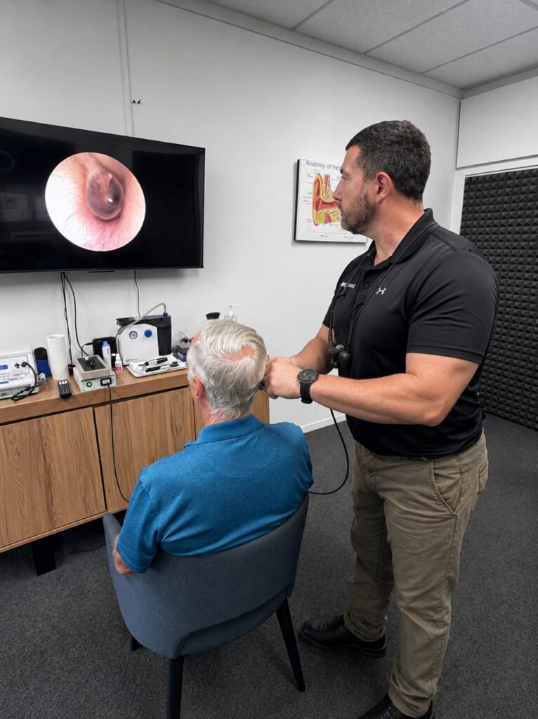 Video otoscopy ear examination at AIM Hearing, Avoca, with the ear canal shown on screen